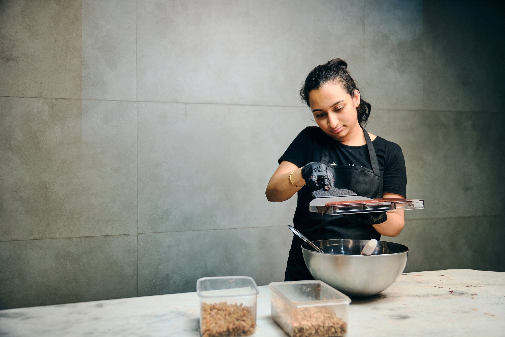 A Prafull's chocolatier moulding a bar by hand